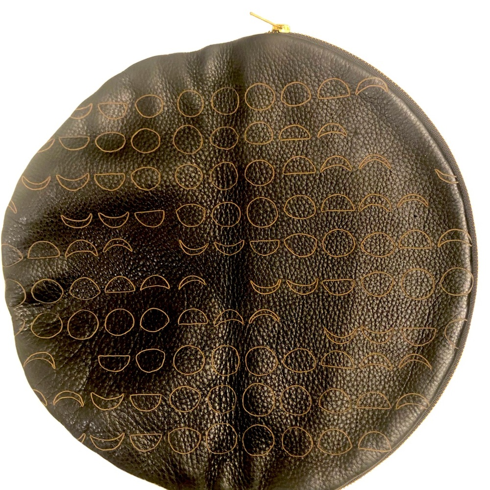 Black pebble leather circle clutch with gold moons